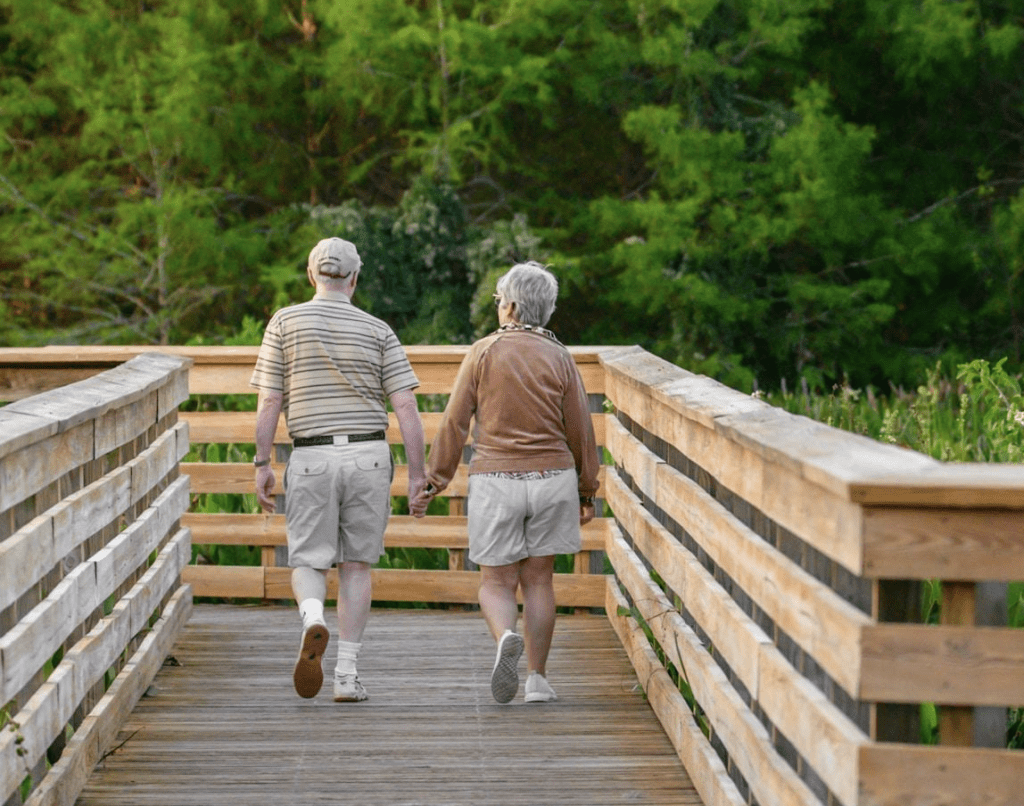 Senior citizens walking.  Image suggests they are walking into their golden years.